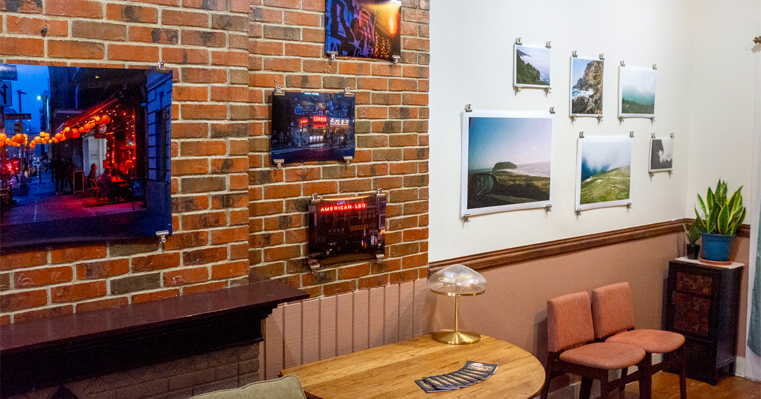 An installation of photographs by JP Wojciechowski and Eve Wong for the first exhibition of Salad. Wojciechowski's photos, hanging over brick in the foreground, illuminate New York City street scenes in moody blues and reds, while Wong's photos, deeper in the frame against a white wall, open up scenes of crashing waves and low-hanging clouds in California and New Hampshire.