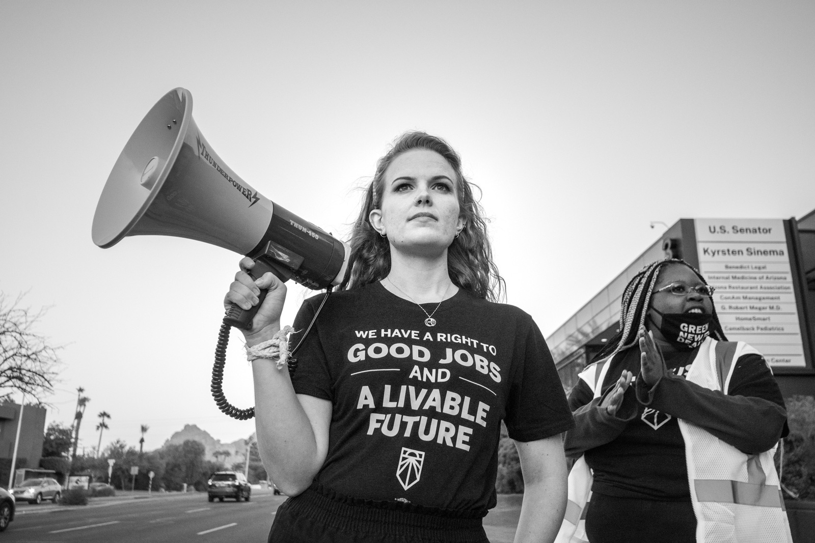 Casey Clowes leads a Sunrise Movement demonstration calling on Senator Kyrsten Sinema to back a Green New Deal